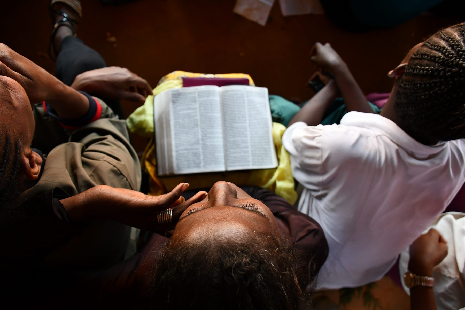 Prayer around an open Bible