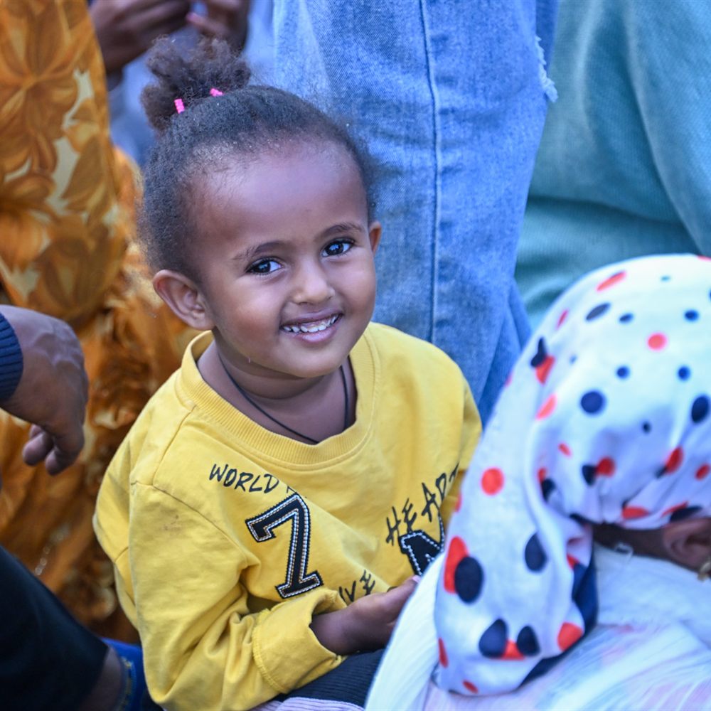 Little girl smiling in yellow