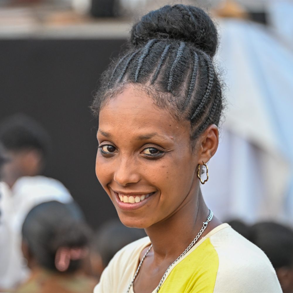 A smiling woman at the crusade field