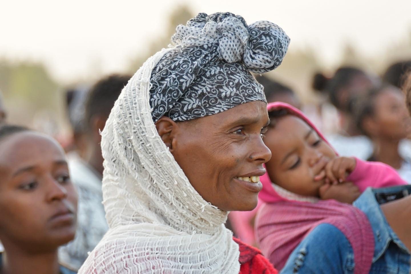 Mother holding a child at a crusade